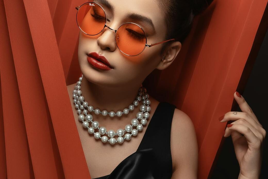 woman in sunglasses with beaded necklace