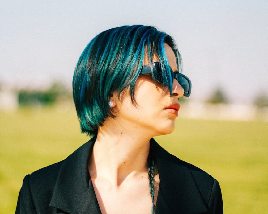 woman with blue hair on the field