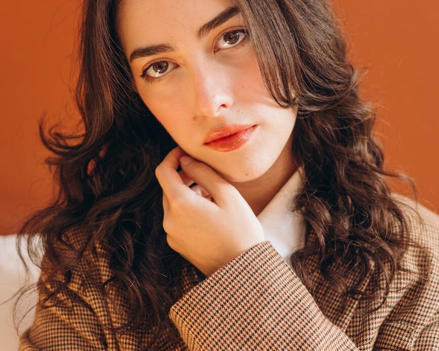 a woman with long hair posing for a portrait