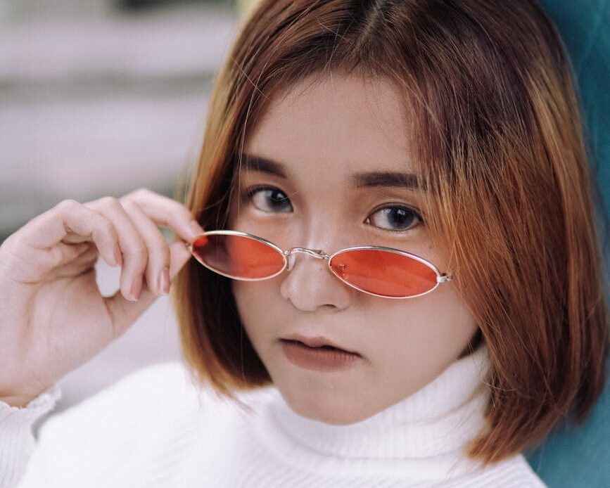 girl with short hair wearing sunglasses