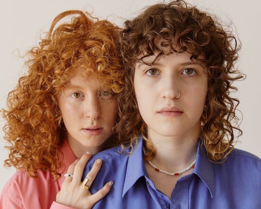 portrait of two young women with curly hair