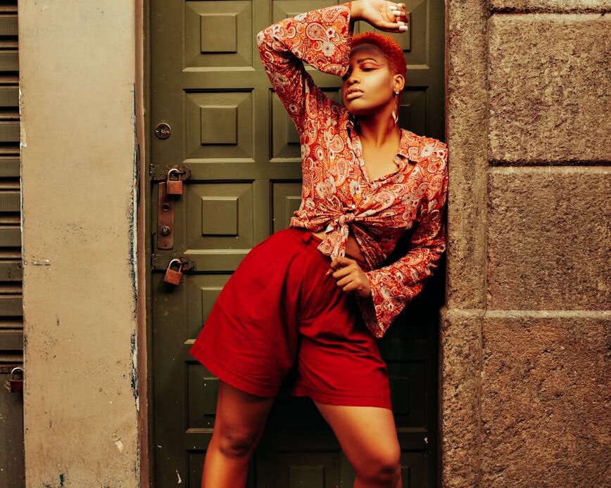 afro american female model standing and posing in recess of door