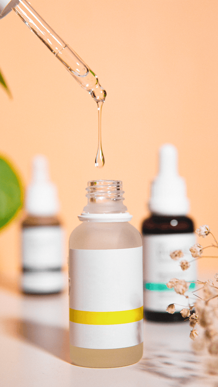 photo of a beauty product in a glass bottle with a pipette