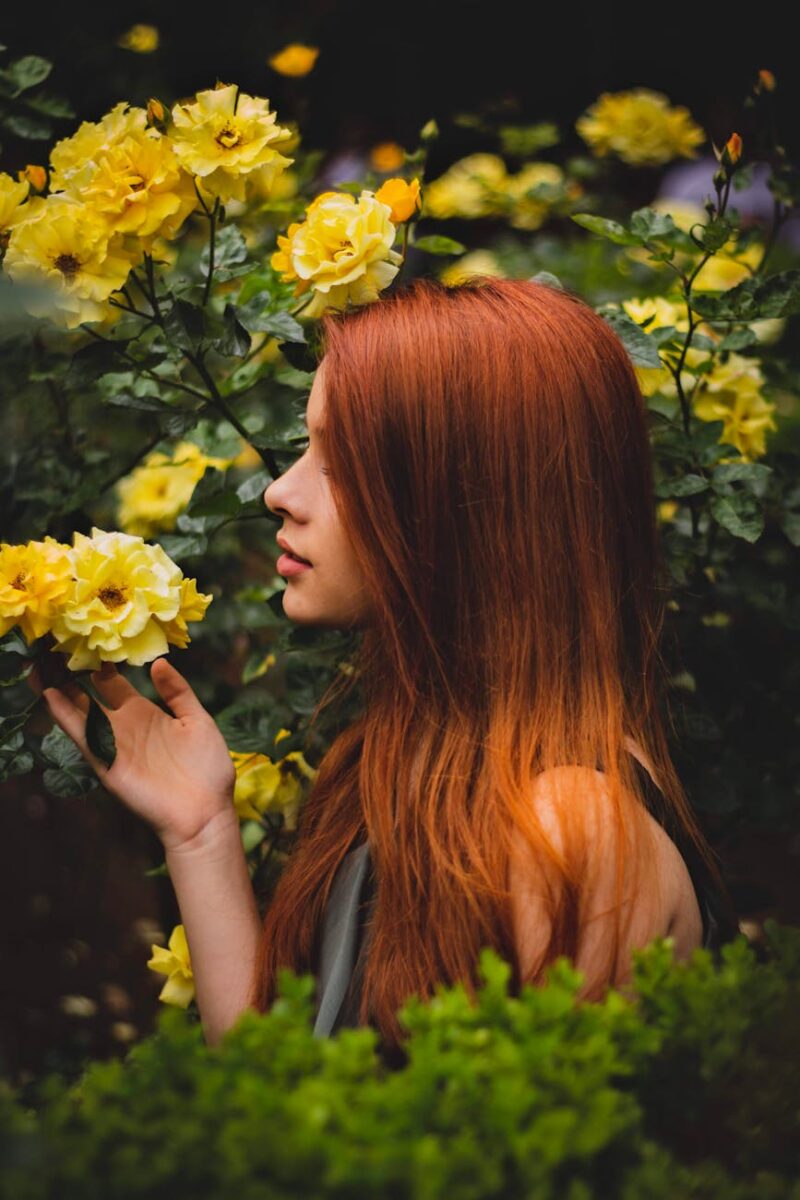 photo of woman holding flower