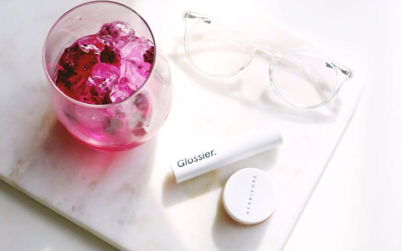 cup beside eyeglasses