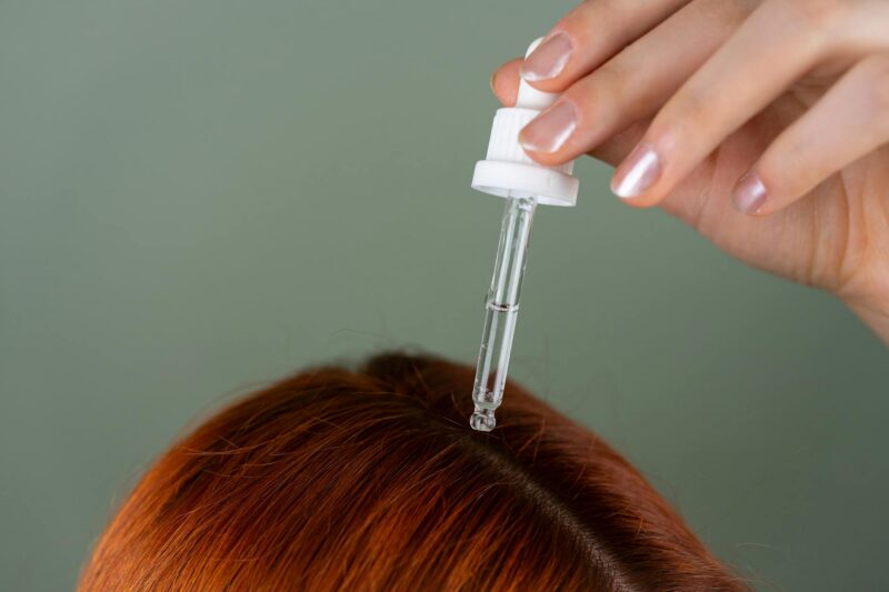 applying hair serum with precision dropper