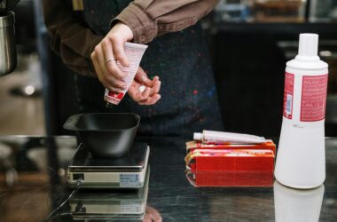 person holding white and red labeled pack