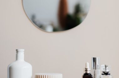 set of cosmetic products on marble shelf in modern room