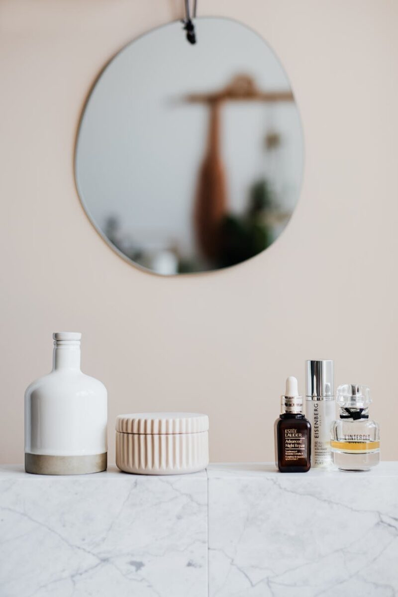 set of cosmetic products on marble shelf in modern room