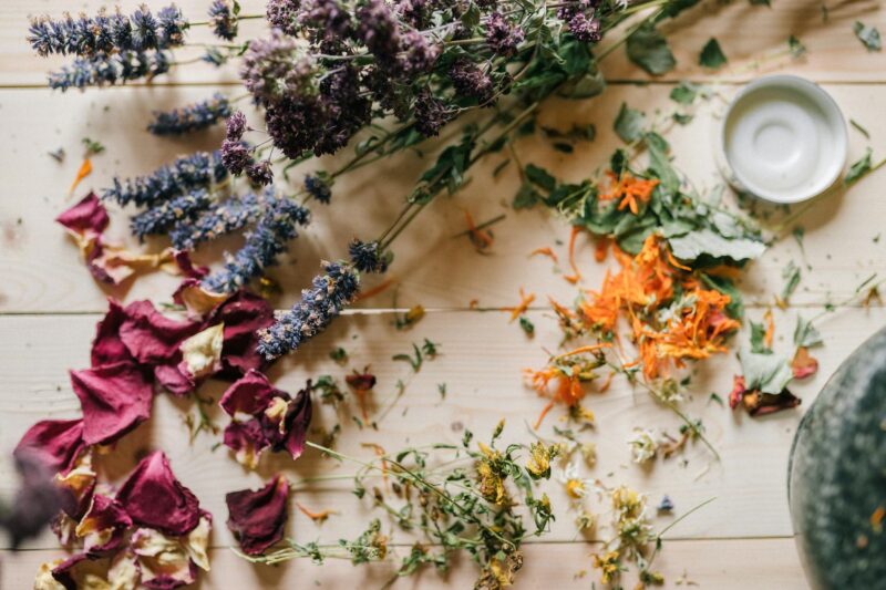 dried flowers and petals on a wooden table