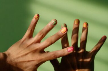 close up shot of hands with colorful nail polish