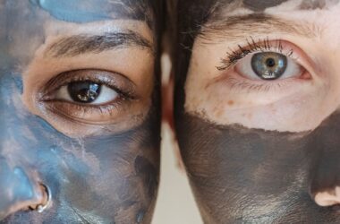 diverse crop females smiling with clay mask