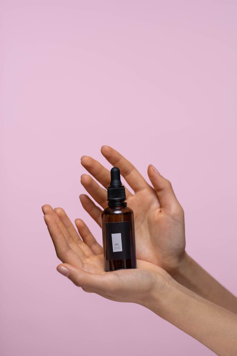 person holding a bottle of serum