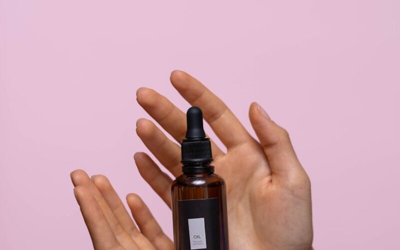 person holding a bottle of serum