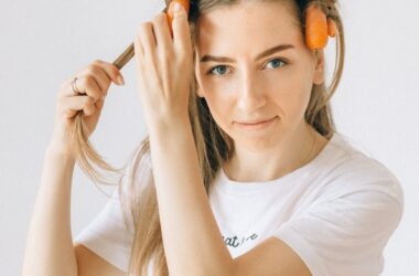 woman in white crew neck t shirt holding her hair