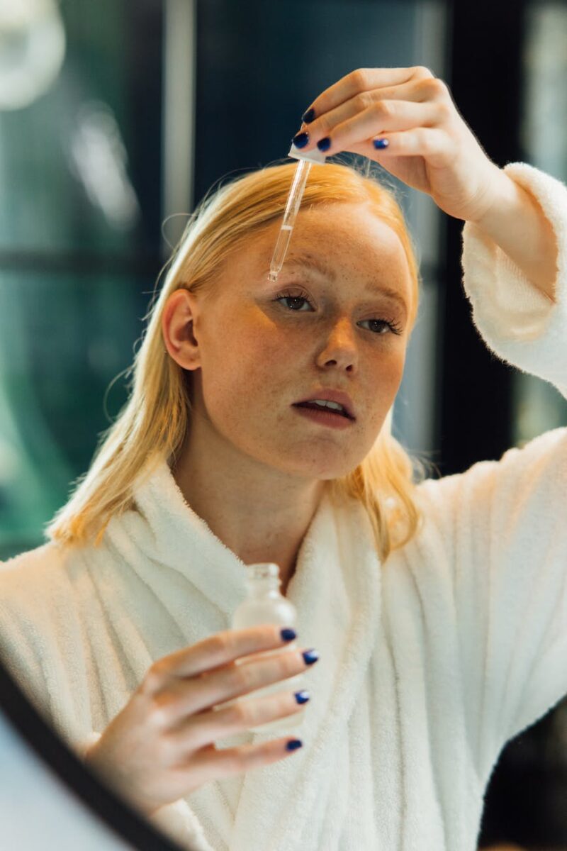 woman putting moisturizer on her face