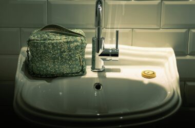 bathroom sink with cosmetic bag and soap