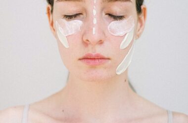 gentle young woman with white facial cream smears