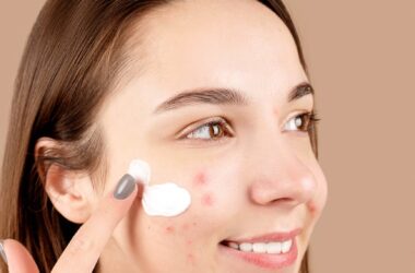 a woman putting cream on her face