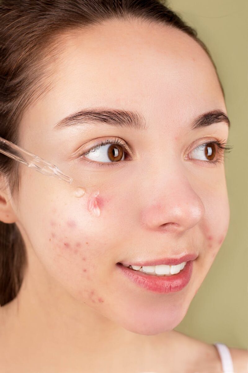 woman applying facial serum