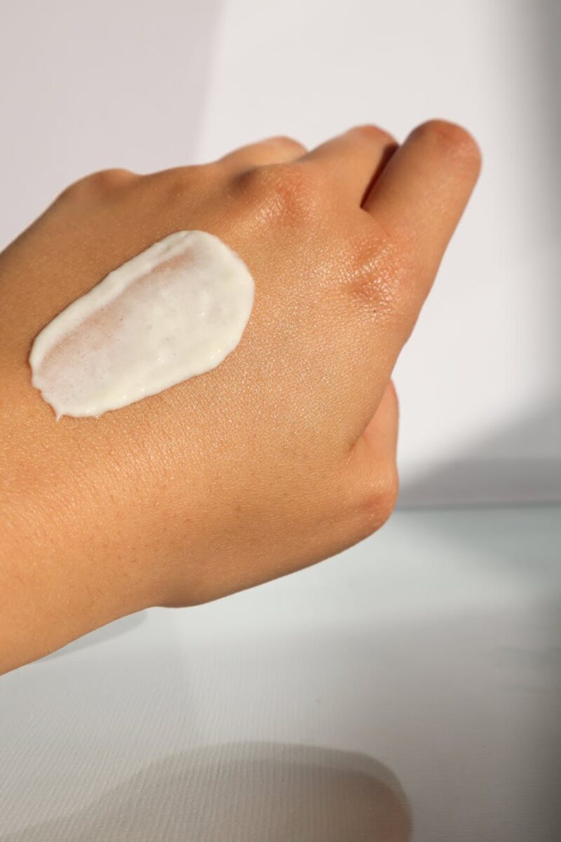 persons hand with white cream