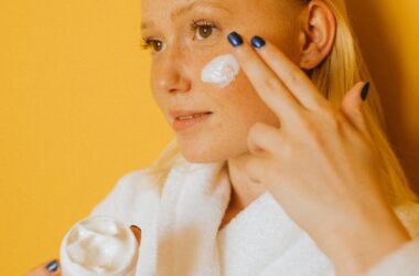 woman putting cream on her face