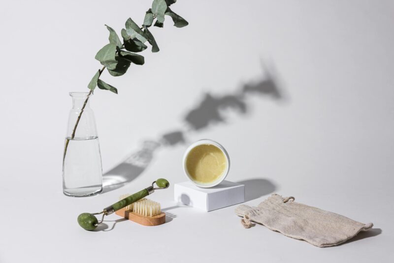 close up photo of beauty product and a facial roller